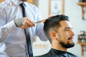 Professional barber  making haircut